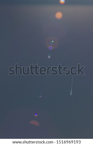 aircraft contrail and  lens flair on summer sky