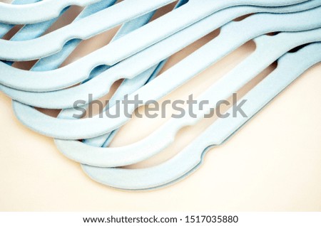 Many blue hangers isolated on bright background. Store concept, sale, design, empty hanger.