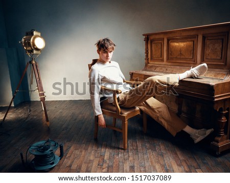 The guy sits near the piano learning music game Studio