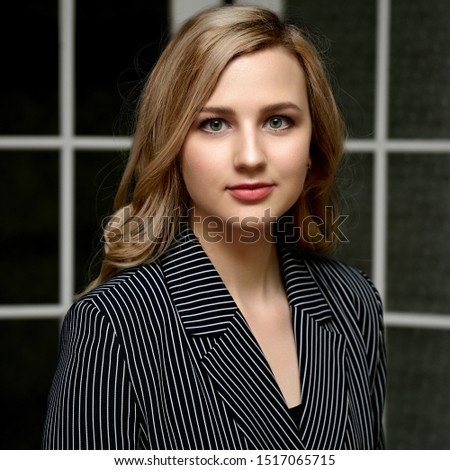 Portrait of a pretty young blonde girl with beautiful hair, excellent make-up, beautiful face skin in a jacket on a colored background. Made in the studio.