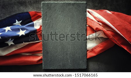 American flag on a black stone background. Space for text.