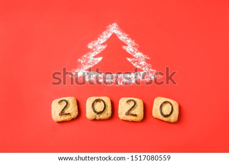 Flour Silhouette Christmas Tree with cookies digits 2020 on red background. Delicious bakery sweet confectionery Christmas card. Idea of merry new year xmas 2020 holiday.