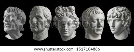 Five gypsum copy of ancient statue heads isolated on a black background. Plaster sculpture mans faces. Royalty-Free Stock Photo #1517104886