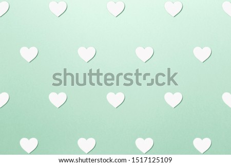 Valentine's Day postcard. Valentine's Day Background. Trendy pattern made with paper hearts on bright mint background. Minimal style with colorful paper backdrop. Minimal creative concept. Neo mint