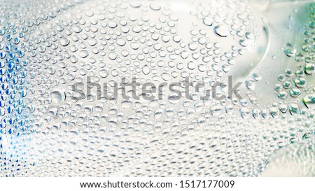 Abstract water droplets on the clear bottle with white background.