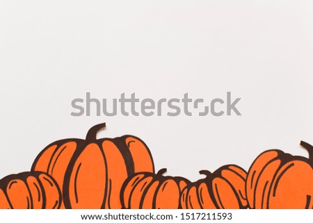 Halloween decorations with paper pumpkins on white background. Halloween and decoration concept. Flat lay, top view, copy space