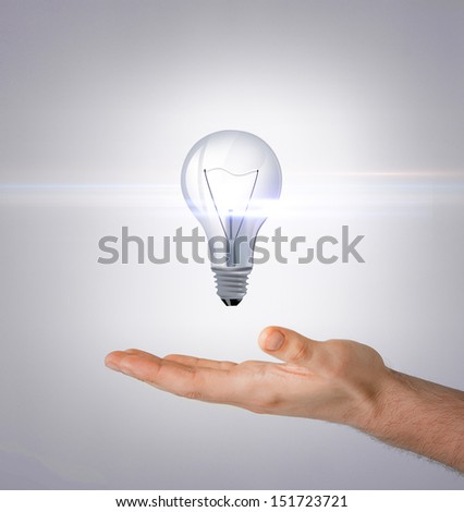 energy and environment concept - man hand with light bulb