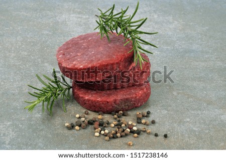 Raw chopped steaks with rosemary and spices