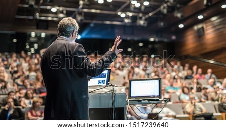 Speaker giving a talk on corporate business conference. Unrecognizable people in audience at conference hall. Business and Entrepreneurship event. Royalty-Free Stock Photo #1517239640