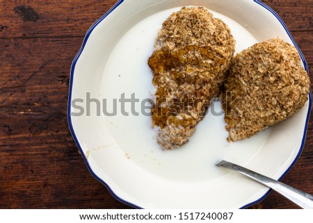 Directly above shot of whole grain wheat breakfast cereal in a bowl with milk