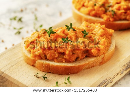 Bread with homemade caviar vegetables - squash, zucchini, tomatoes, onions, carrots, bell peppers and hot peppers  Royalty-Free Stock Photo #1517255483