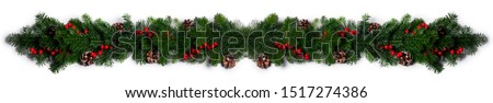 Christmas Border frame of tree branches red berries and pine cones on white background with copy space isolated