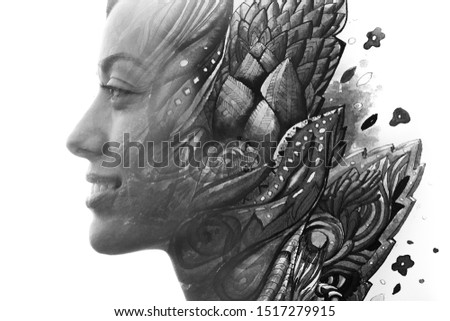 Paintography. Double exposure of woman's profile dissolving into hand drawn leaves with swirls, black and white