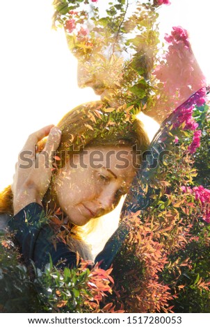 Double exposure of a couple with melancholic sad expression dissolving behind tropical plants