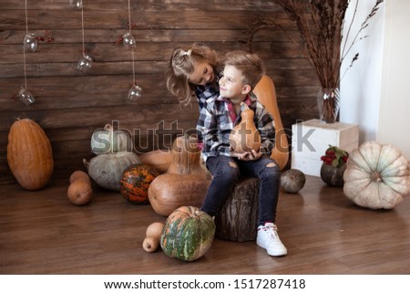 children play at home in autumn with pumpkins
