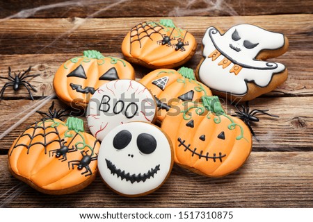 Halloween gingerbread cookies with spiders on brown wooden table