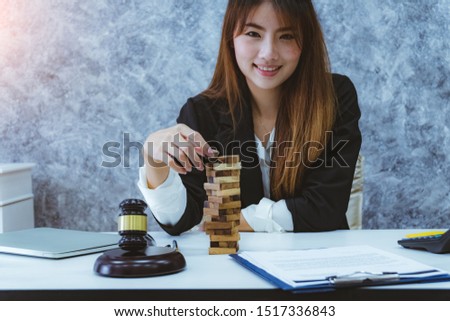 lawyer woman playing people pulls wooden blocks to train court strategy and tacti. Strategic thinking and risk.