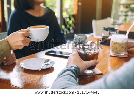 Closeup image of people enjoyed drinking coffee together in cafe