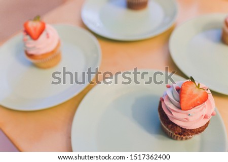 Delicious cupcake with berries on table close up.