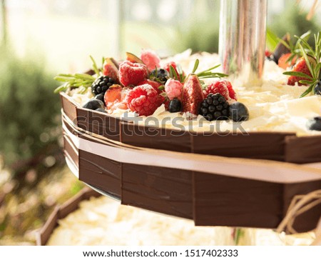 Homemade pastries with fruits and flowers.The cake is decorated with various fresh berries. Summer food. 
