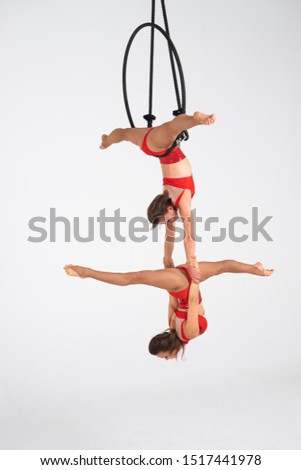 Twins female circus duo on the Aerial hoop isolated on white
