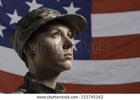 Young military woman pictured in front of US flag, horizontal