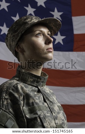 Young military woman pictured in front of US flag, vertical