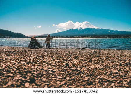 Mom and son playing at Kawaguchiko lake near Mt.Fuji in winter scene