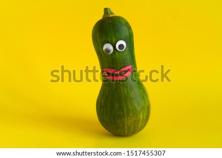 funny vegetable with googly eyes and mouths made of plasticine on a yellow background,GMO foods and hand made games with kids concept