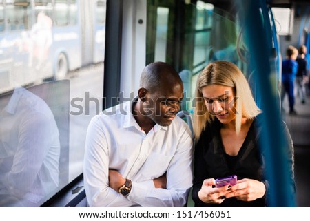 Here's my number, call me. An African man and a blonde girl in public transport