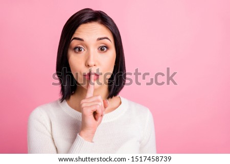 Photo of amazing lady holding finger on lips asking everyone to keep silence and stop talking wear white pullover isolated pink color background