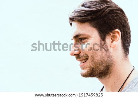 Profile portrait of a young man isolated on white.