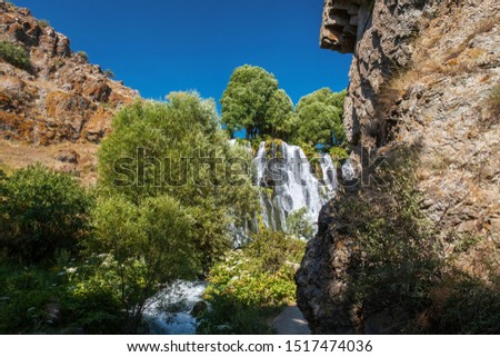 The Shaki waterfall in Armenia. beautiful nature of the Caucasus in the afternoon with a blue sky