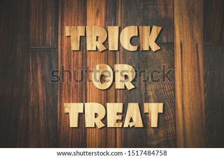 Trick or Treat lettering design on Wooden background