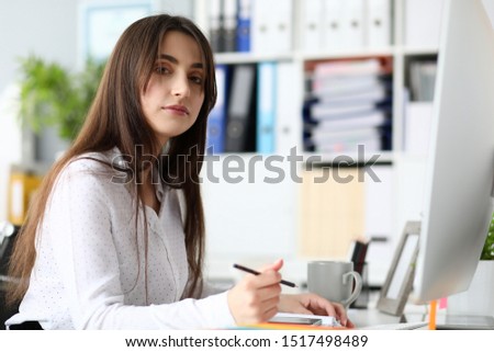 Portrait of serious businesslady drawing project. Beautiful businesswoman working at camera seriously. Business and art design concept. Blurred background