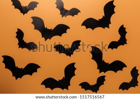 Halloween black paper bats on orange background. Top view Copy space - Image
