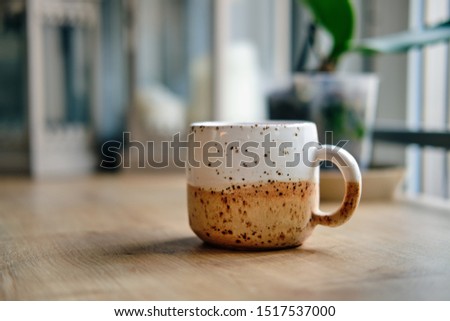 Scandinavian style ceramic cup on wooden table