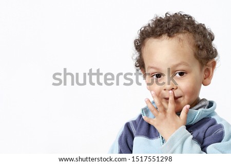 boy picking his nose wiith white background stock photo
