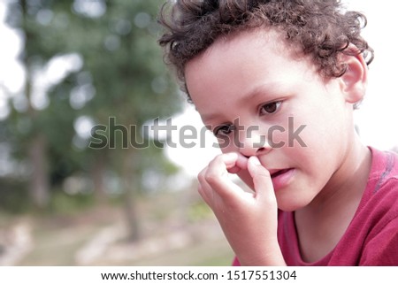 little boy picking his nose stock photo