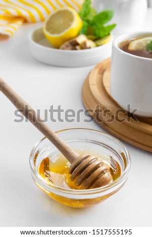 Golden natural honey in glass bowl plte autumn winter hot drink ingredient glass spoon seasonal
