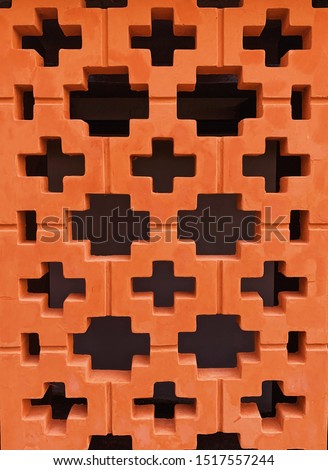 Plus pattern on the orange wall