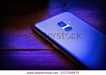 blue mobile phone on a wooden background