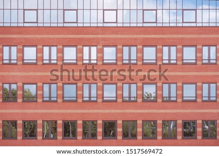 Facade of office building with windows. Facade of an old red brick wall with windows. Old red brick wall with windows.