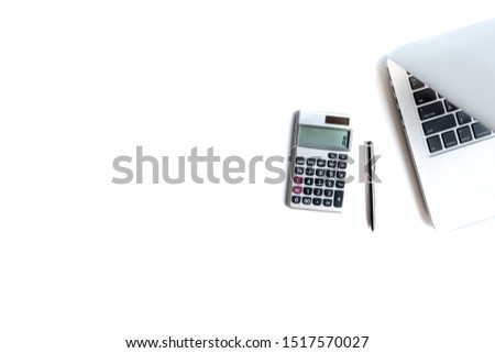 Flat lay, top view office table desk. Workspace with calculator,pen,laptop on white background.Copy Space for text,Empty Blank to word.Business Finance,Education Technology.Work from home. Royalty-Free Stock Photo #1517570027