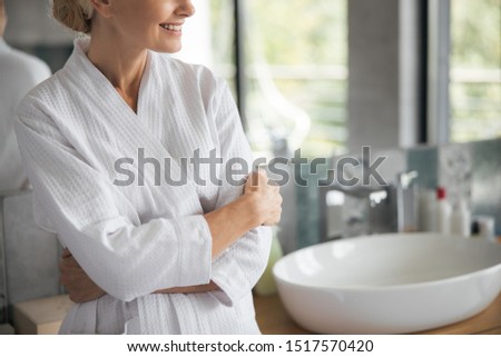 Home atmosphere. Kind woman crossing arms on chest while enjoying her calm morning Royalty-Free Stock Photo #1517570420