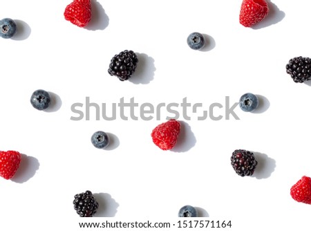 Raspberries, blueberries and blackberries seamless contrast pattern with shadows on the white background. Top view.