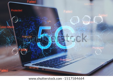 Laptop on desktop with abstract 5G network hologram. Internet and web speed concept. Double exposure 