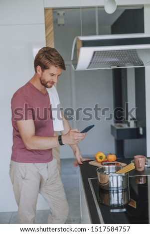 Handsome young male taking a picture of his cooking