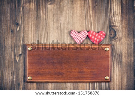 Love hearts, signboard frame on vintage wood background
