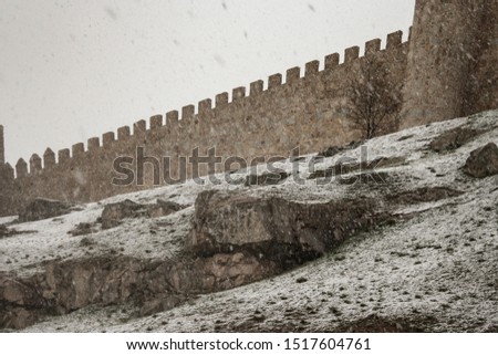 Snowed walls tower at Avila, Spain